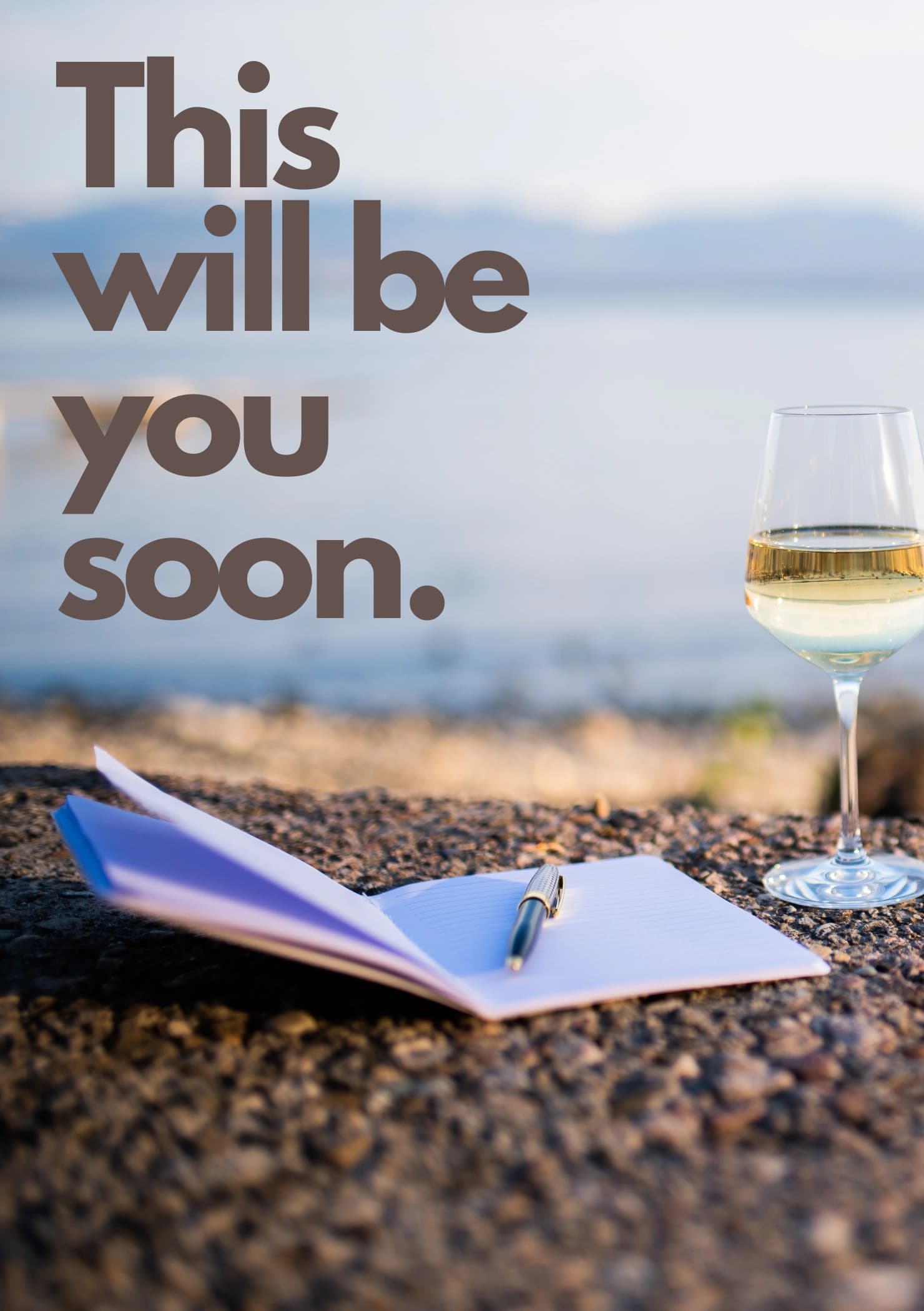 Photo of a notepad and pen with a glass of wine by the coast. The caption reads "This will be you soon".